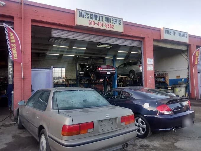 The shop on San Pablo Ave: a red brick garage with the Dave’s Complete Auto Service sign, cars on the lifts inside